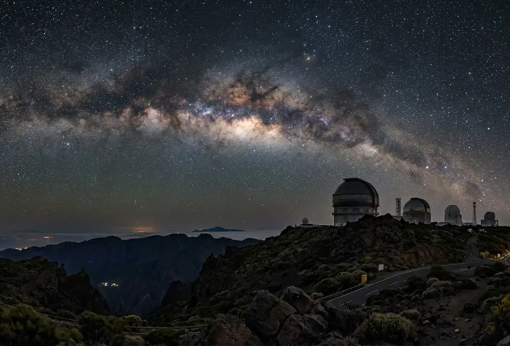 Milky Way arching over the Roque de los Muchachos Observatory domes on La Palma, Bortle 1-2 dark sky above the Caldera de Taburiente rim at 2,396 metres