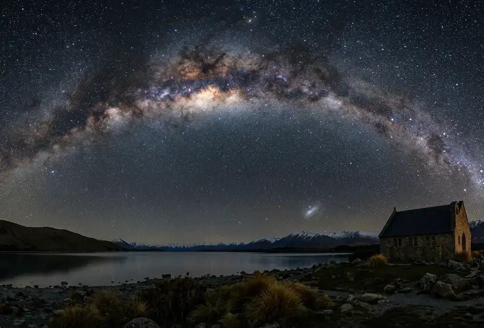 Milky Way galactic core arching directly overhead above Lake Tekapo, Southern Cross and Magellanic Clouds visible in the dark sky above Aoraki Mackenzie, a southern sky stargazing guide to Aoraki Mackenzie's Gold Tier reserve